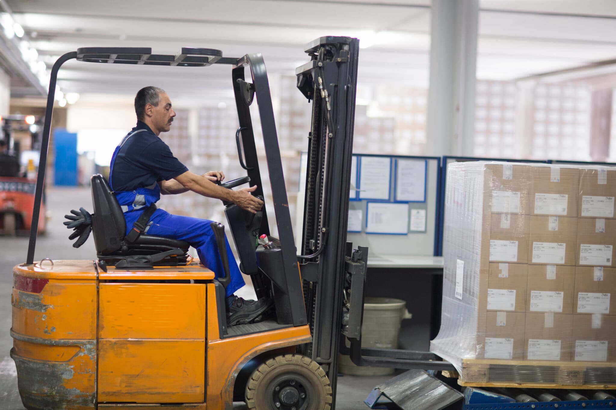 Factory worker operating a forklift